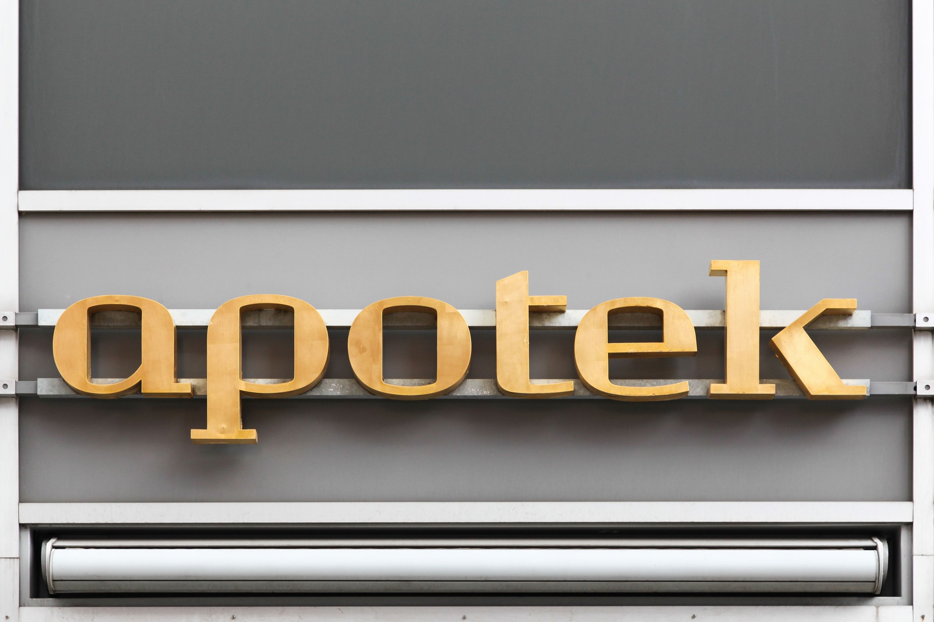 Pharmacy sign on a wall called apotek in Danish language